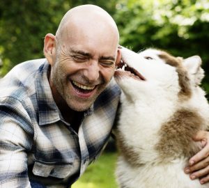 a man with a Siberian Husky dog